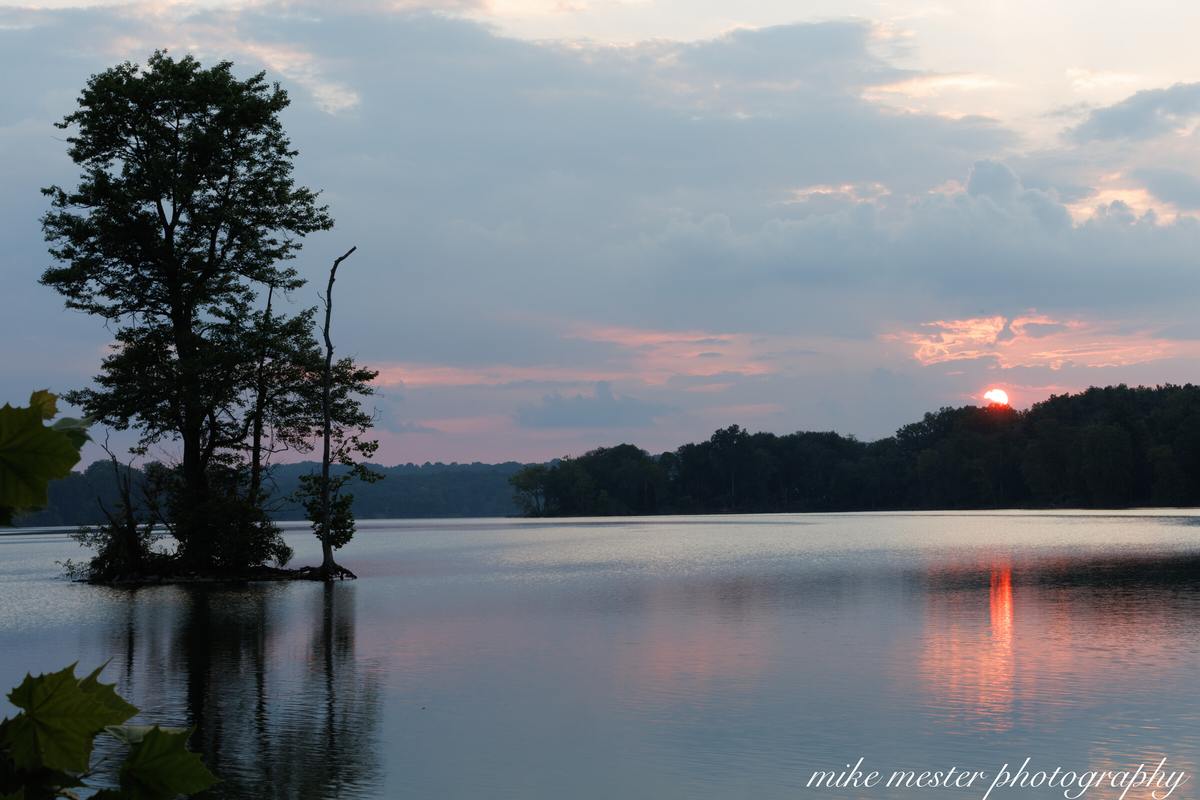 Warm sunset reflected across a quiet reservoir